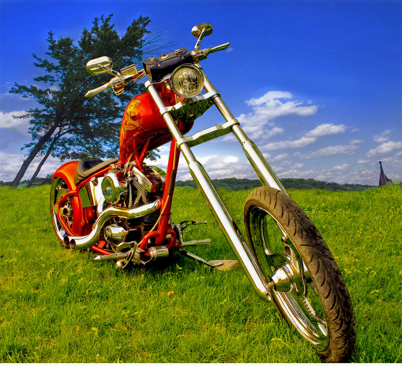 Red chopper motorcycle in field