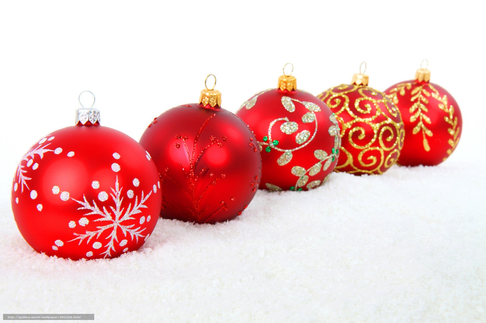 Red Christmas ornaments in snow
