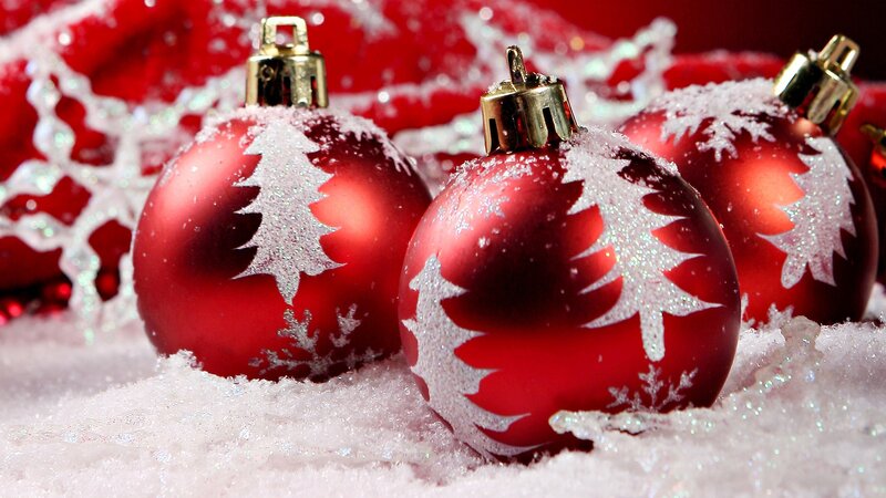 Red Christmas ornaments in snow