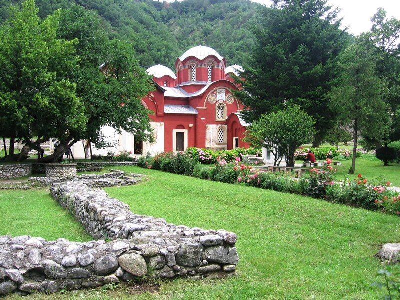 Red church in a green valley