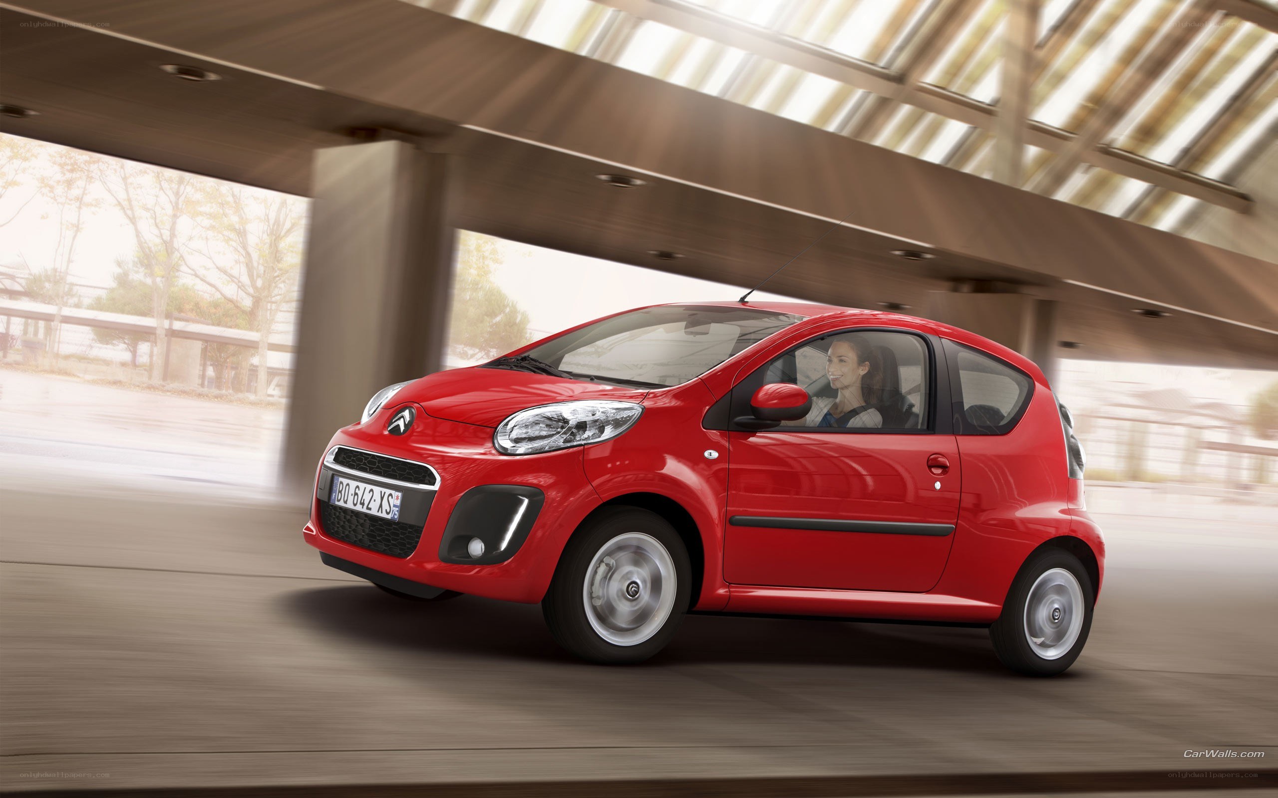 Red Citroën C1 in motion