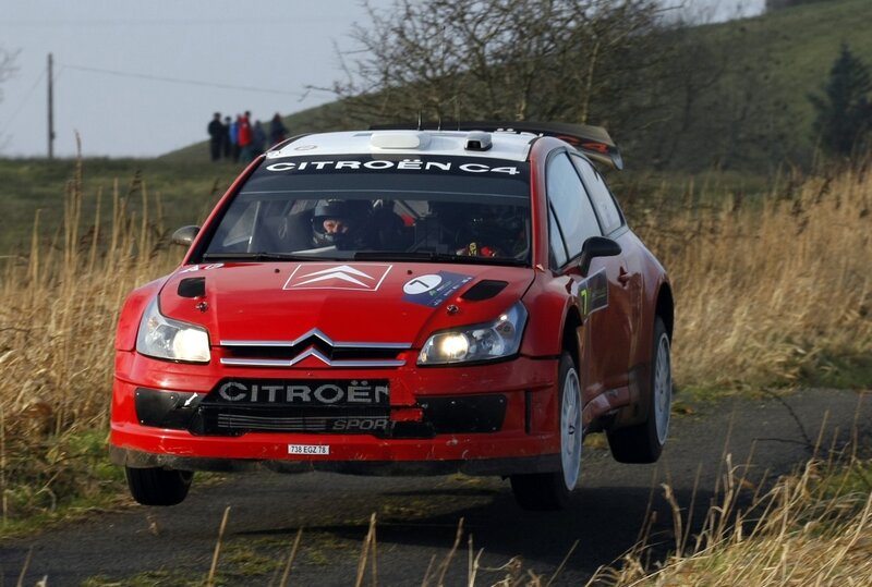 Red Citroën C4 rally car in action