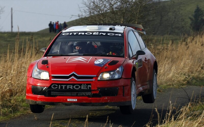 Red Citroën C4 rally car in action