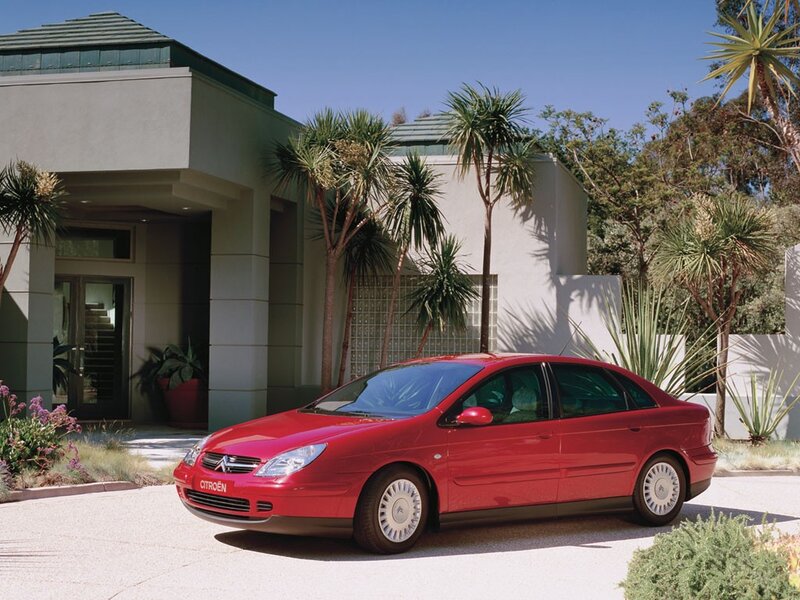 Red Citroën C5 parked outside house