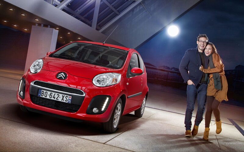 Red Citroën car with couple