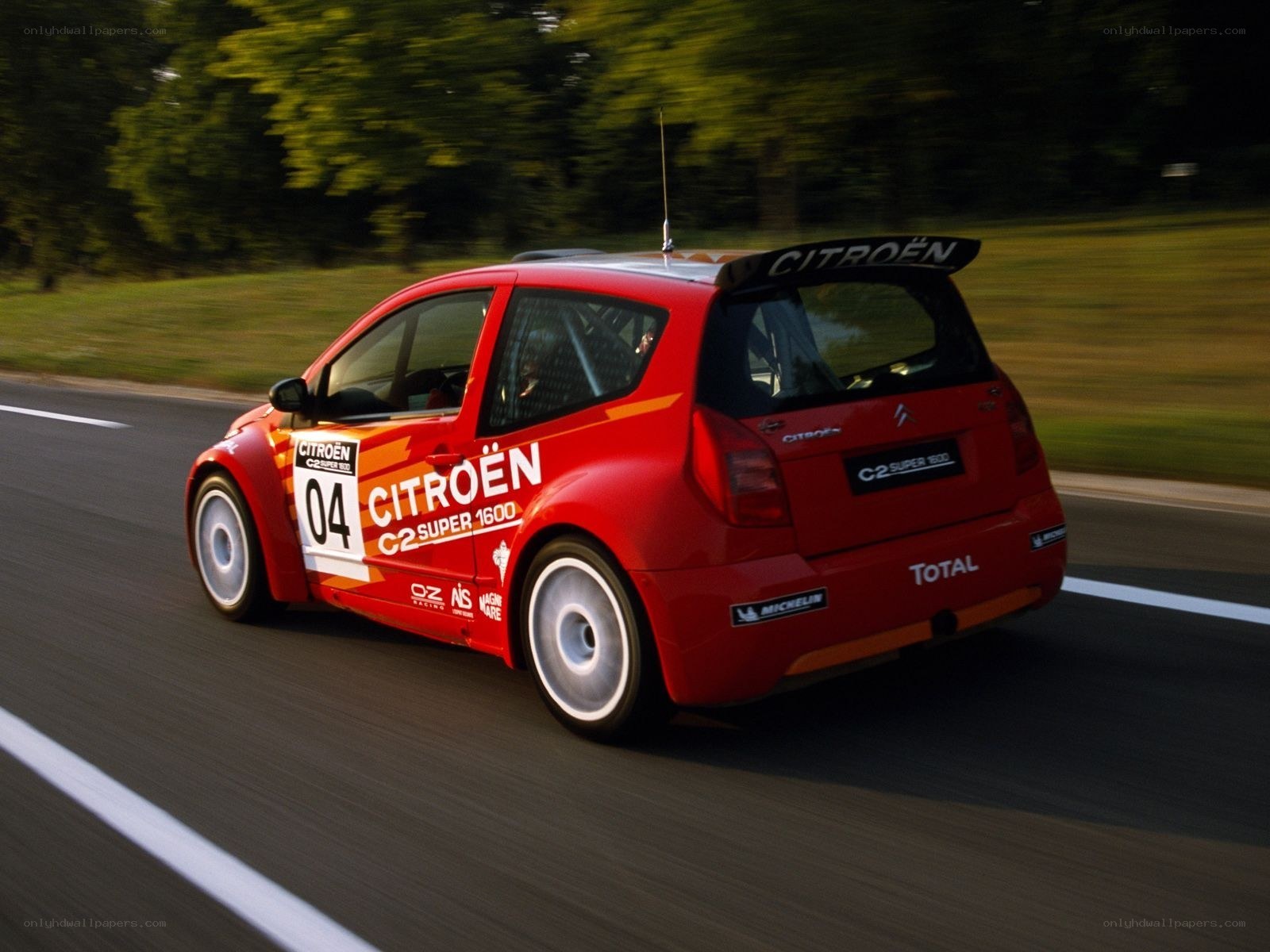 Red Citroën rally car in motion