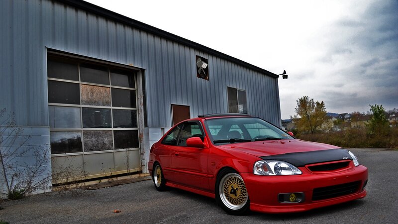 red civic in front of garage