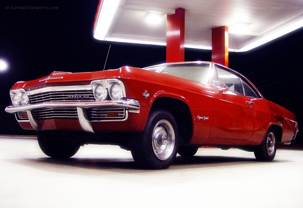 Red classic car at gas station