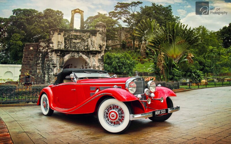 Red classic car at historic site