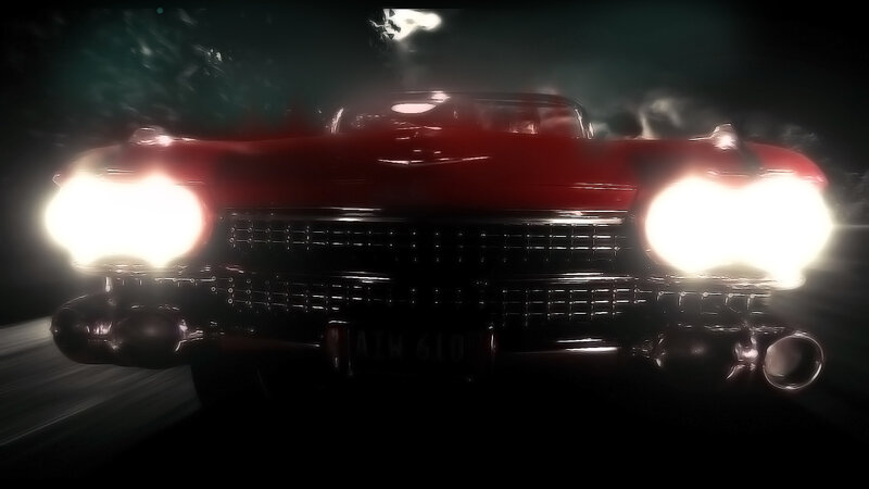 Red classic car at night