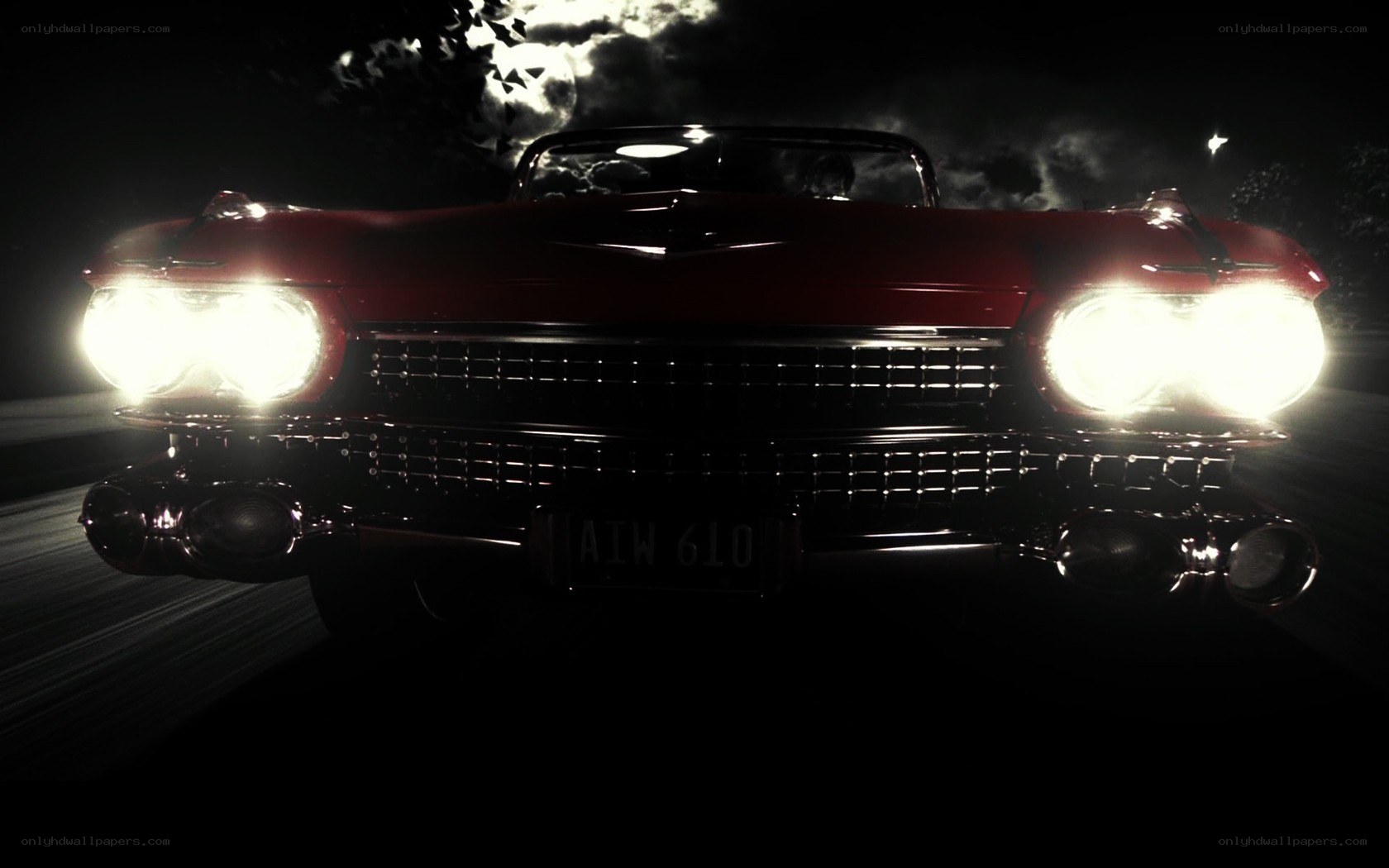 Red classic car at night