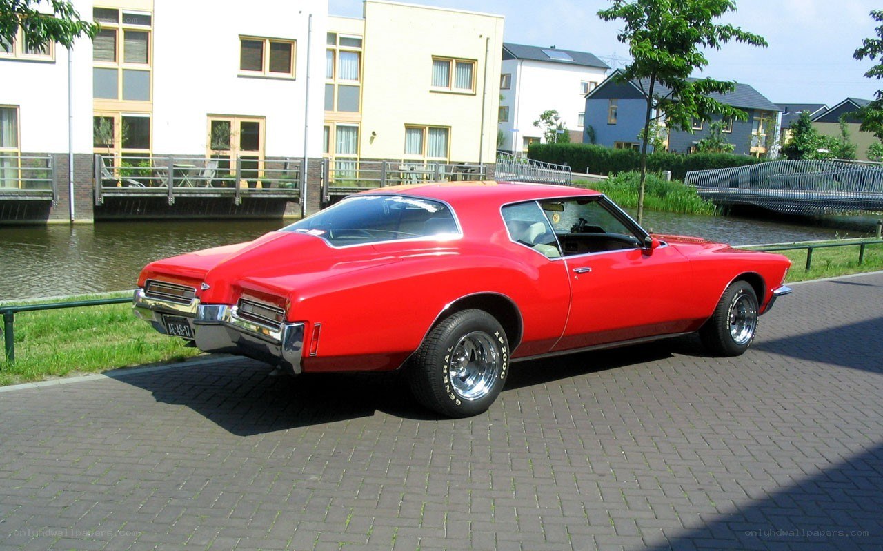Red classic car by canal