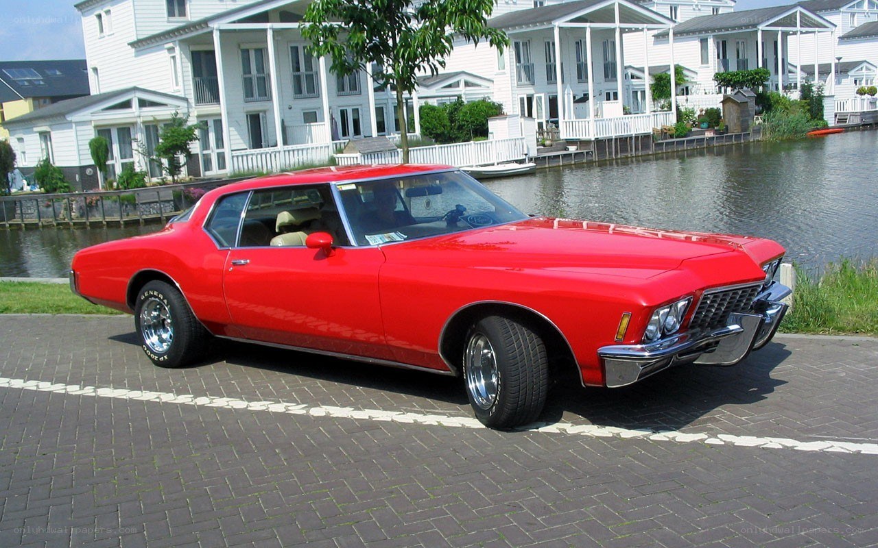 Red classic car by canal