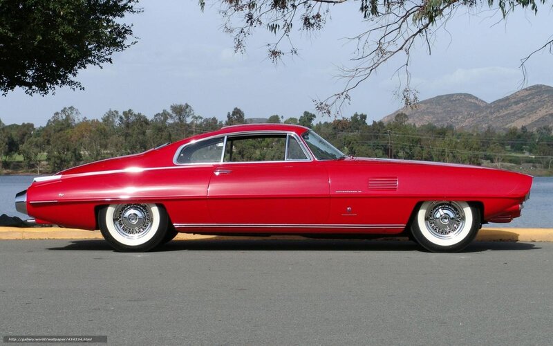 Red classic car by the lake