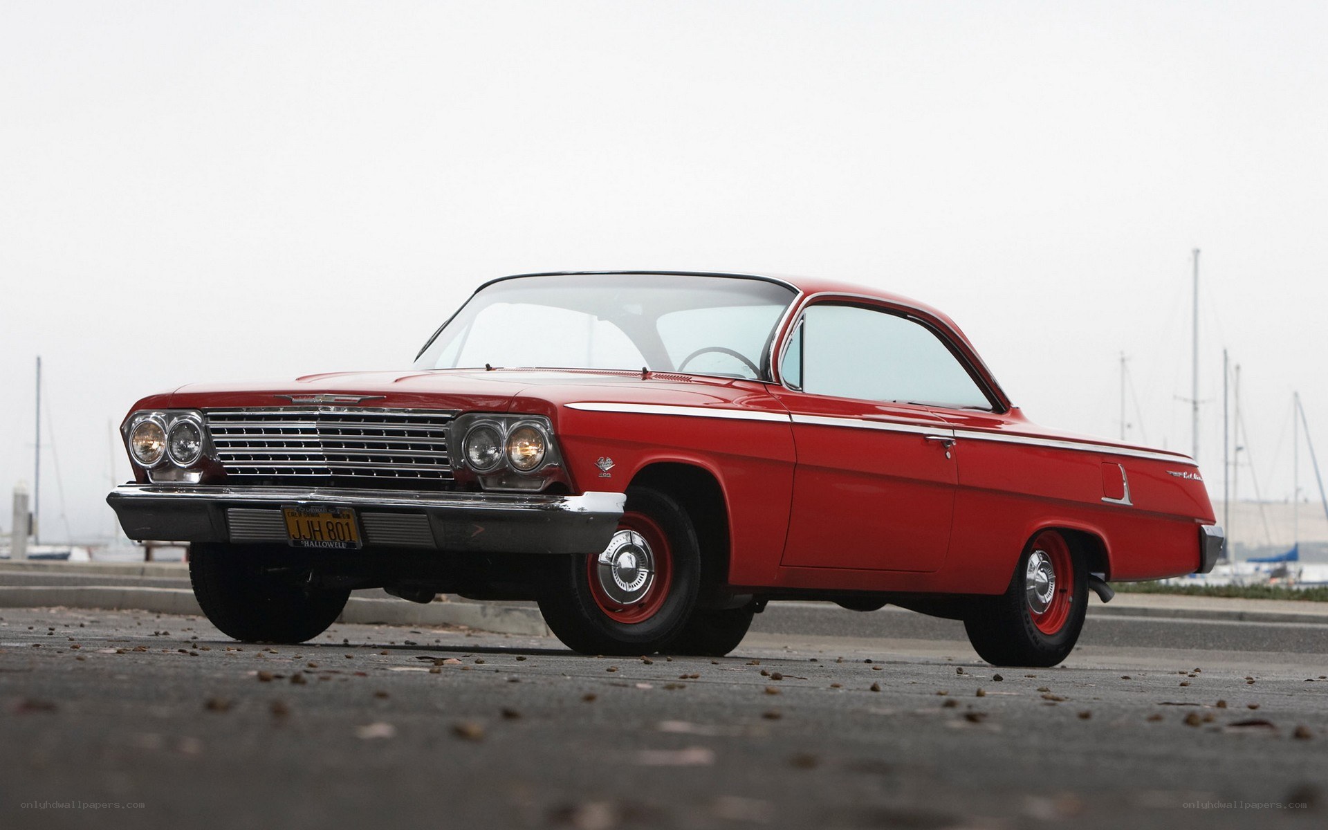 Red classic car by the water