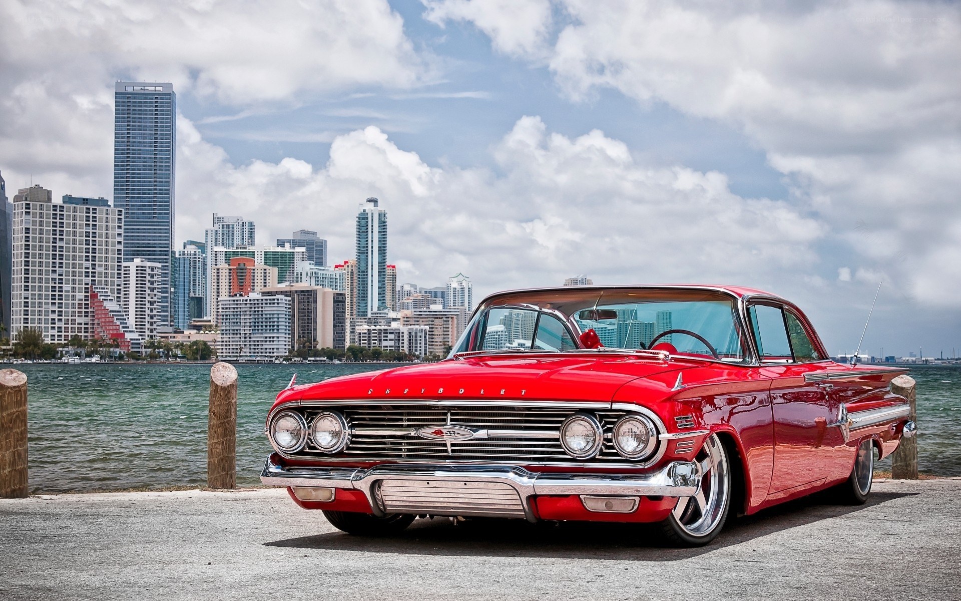 Red classic car by the waterfront
