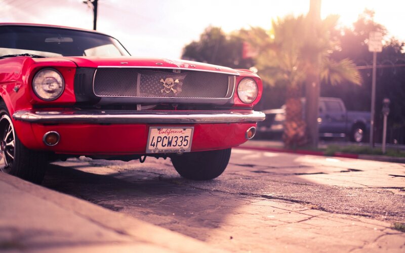Red Classic Car — Dramatic, Sunset, Photograph, Skull Emblem