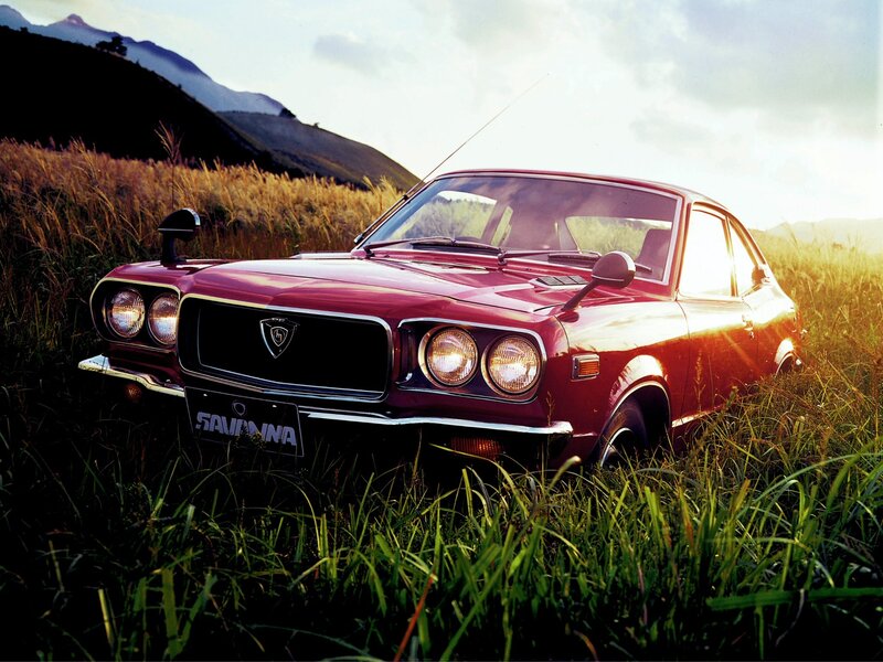 Red classic car in a field