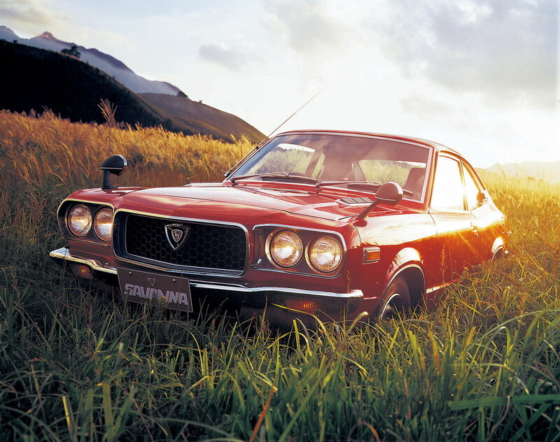 Red classic car in a field
