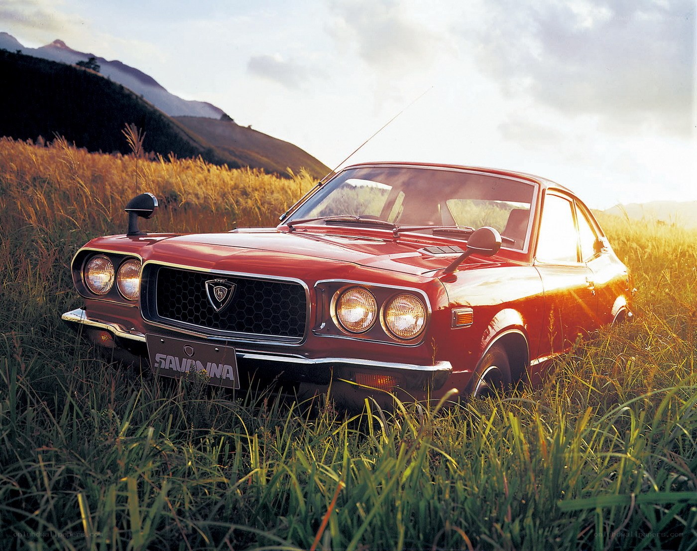 Red classic car in a field