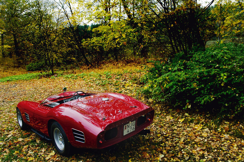 Red classic car in autumn forest