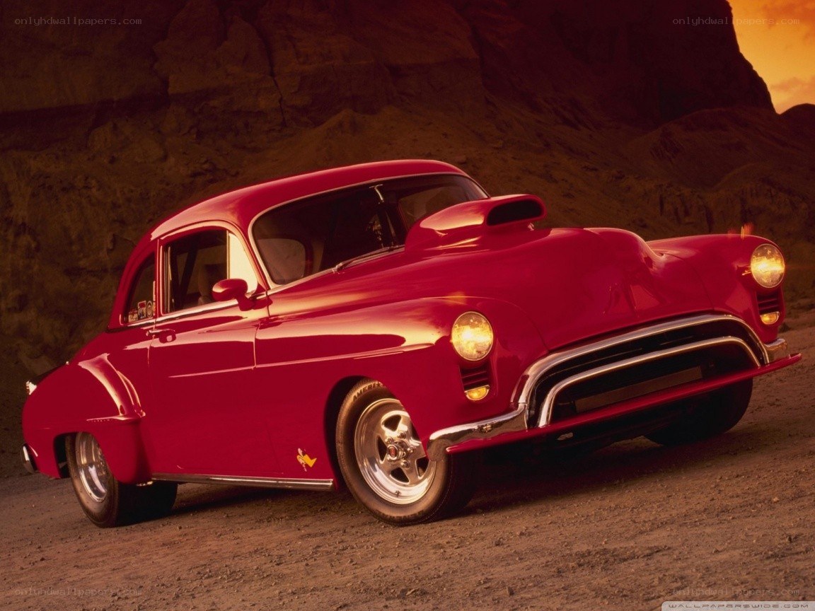 Red classic car in desert