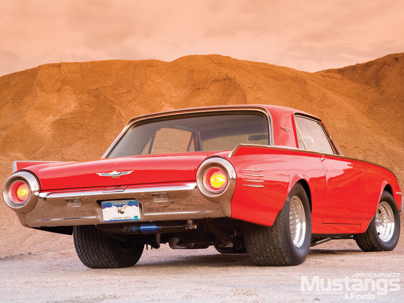 Red classic car in desert