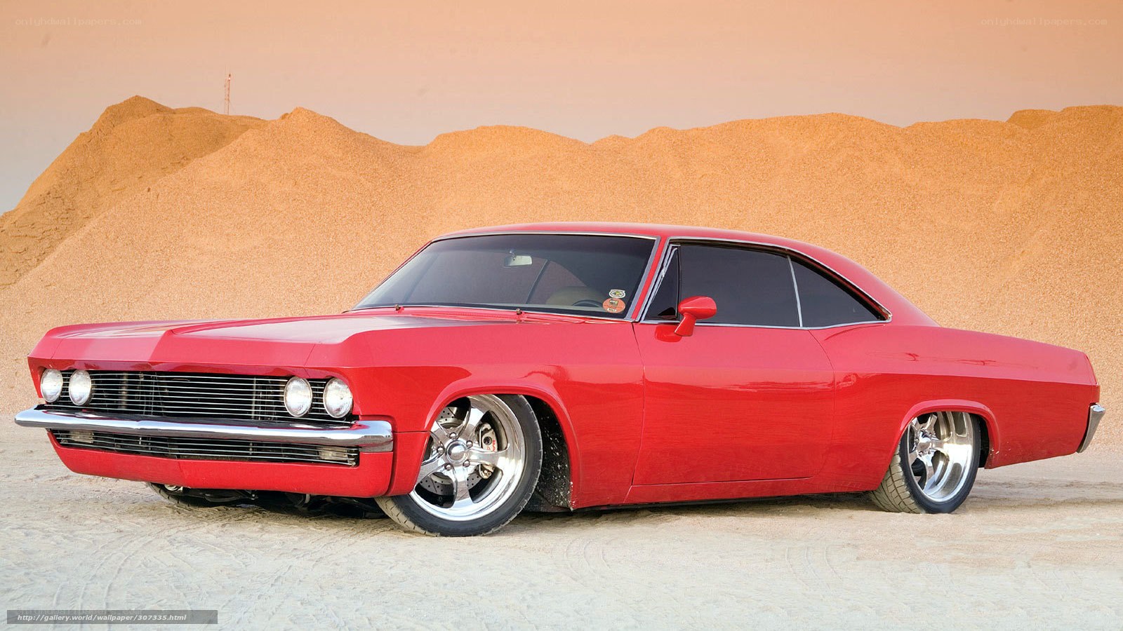 Red classic car in desert