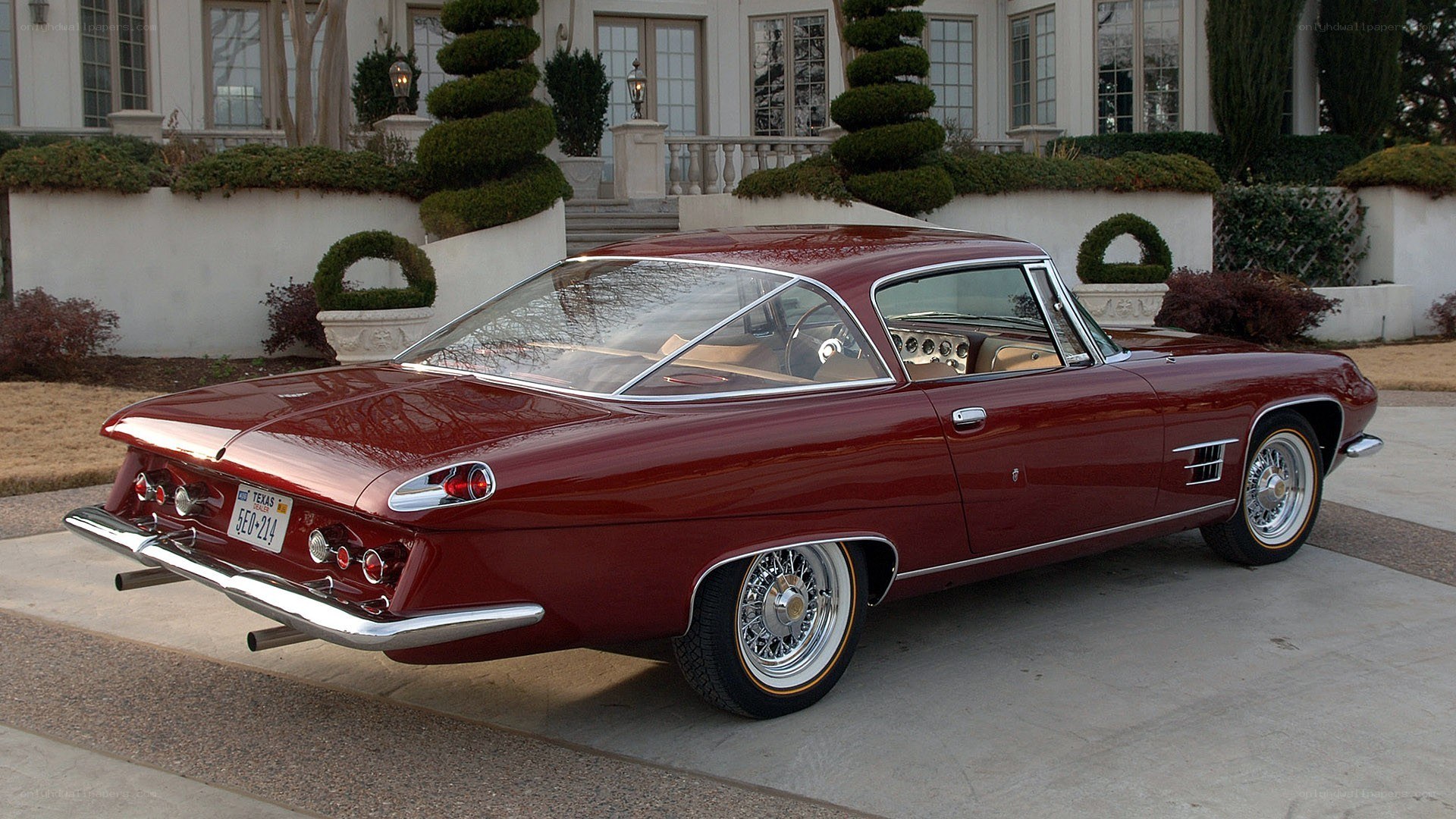 Red classic car in driveway