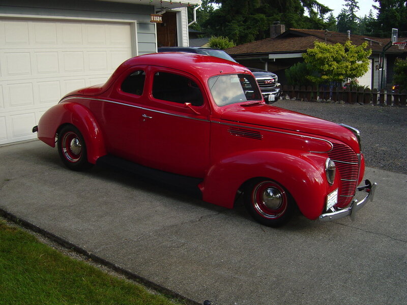 Red classic car in driveway