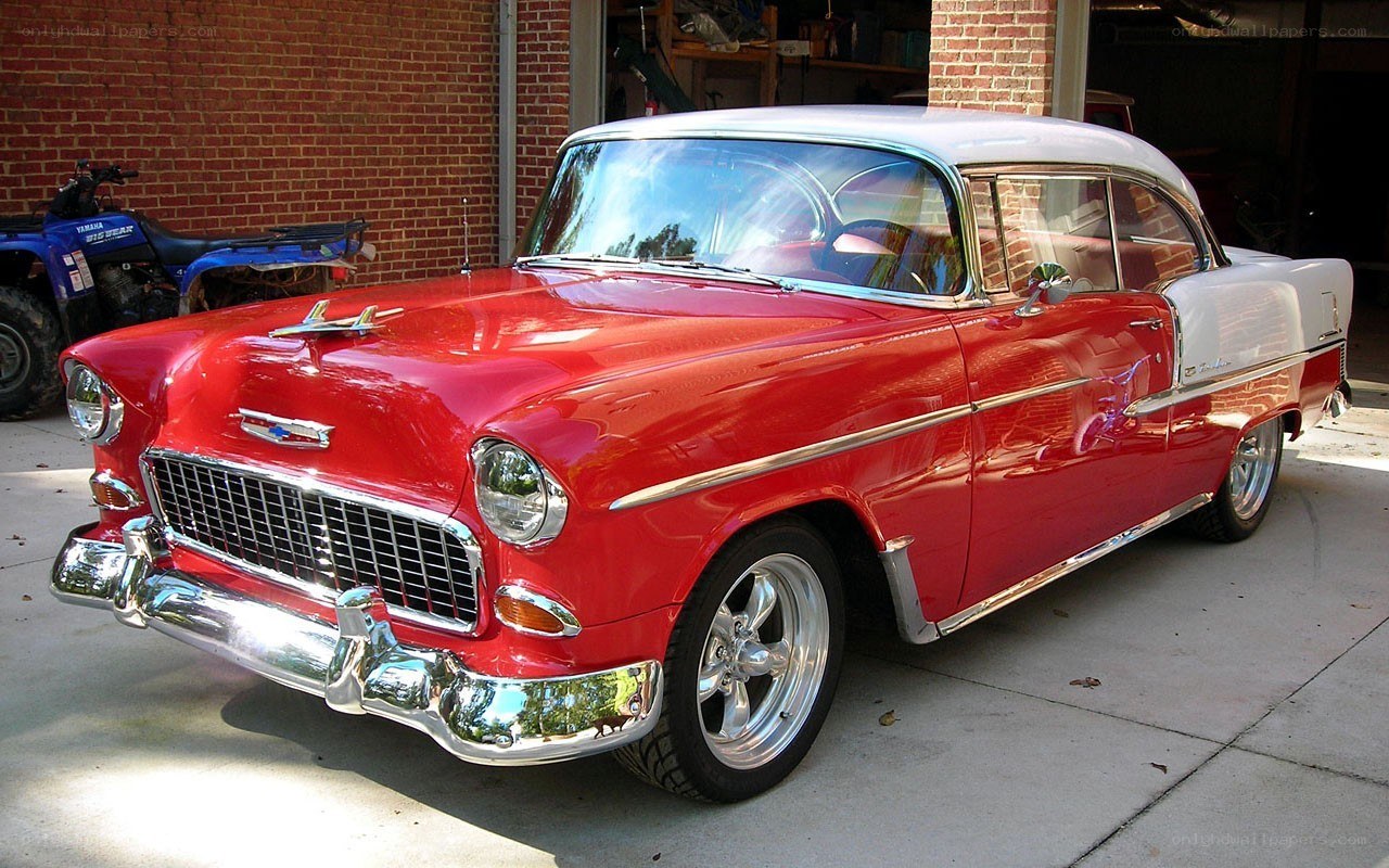 Red classic car in driveway