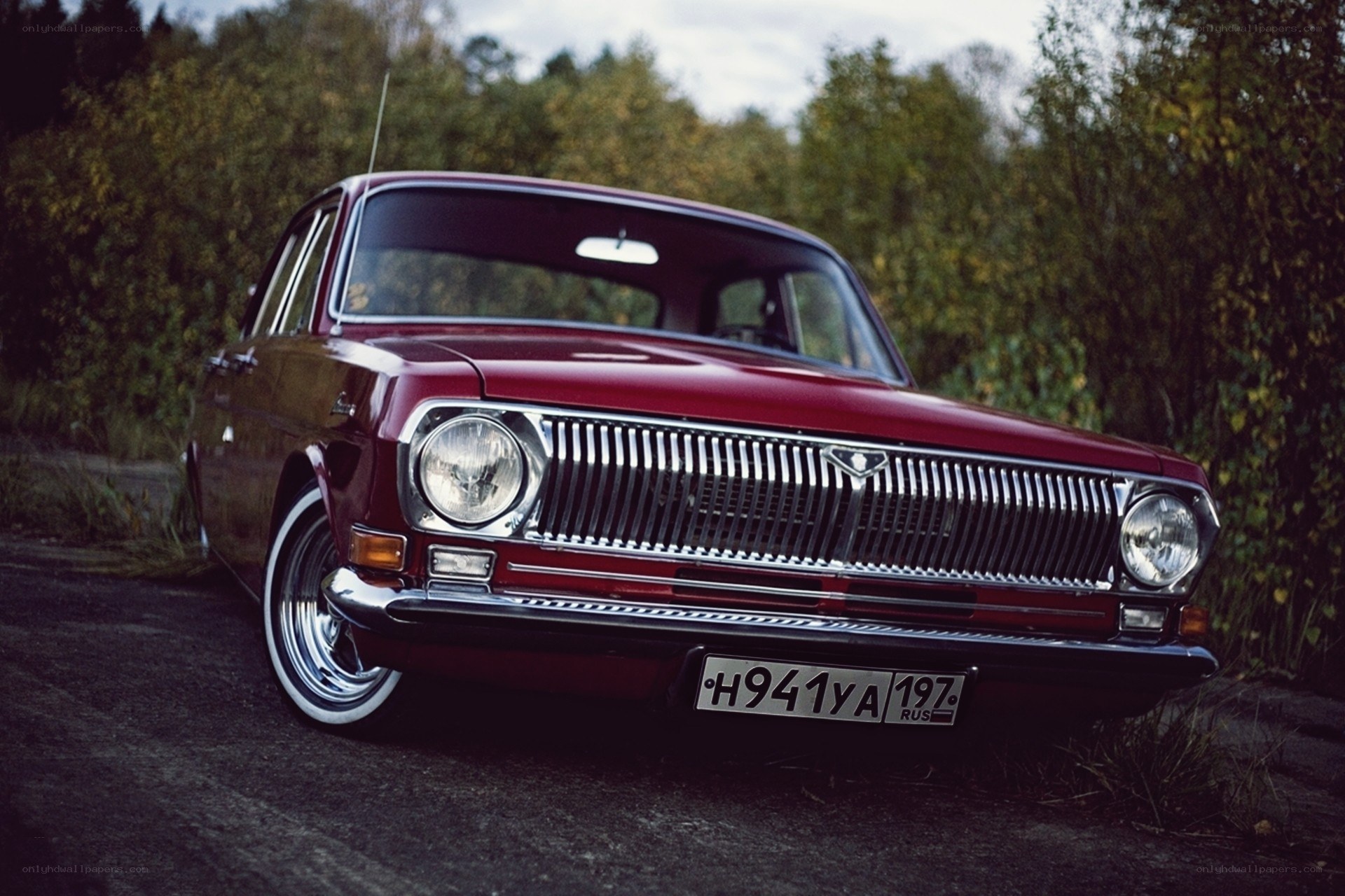 Red classic car in forest