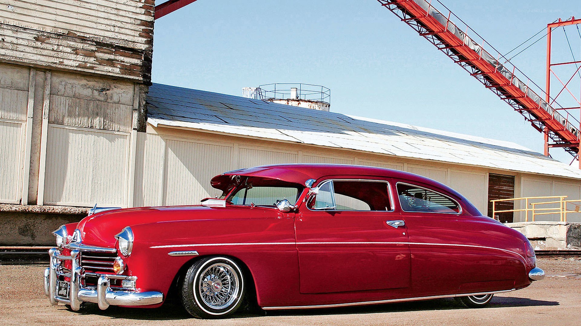 Red classic car in industrial setting
