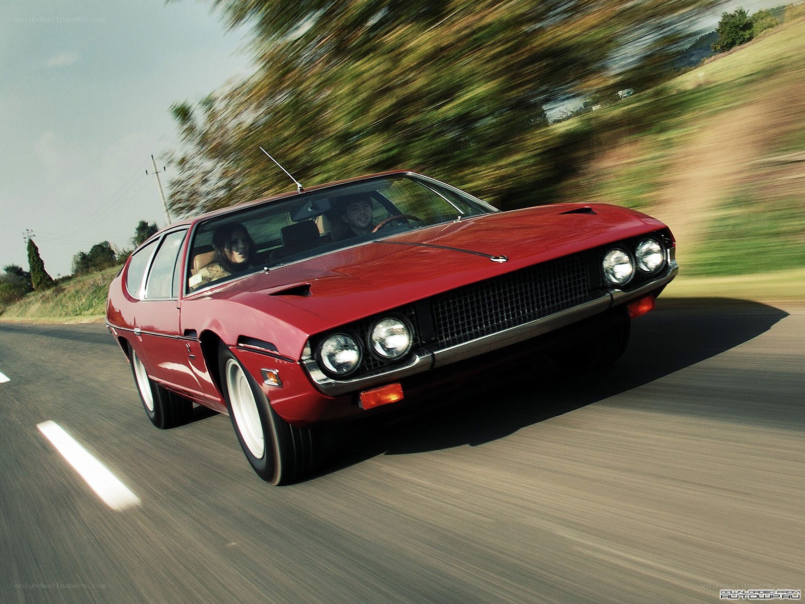 Red classic car in motion
