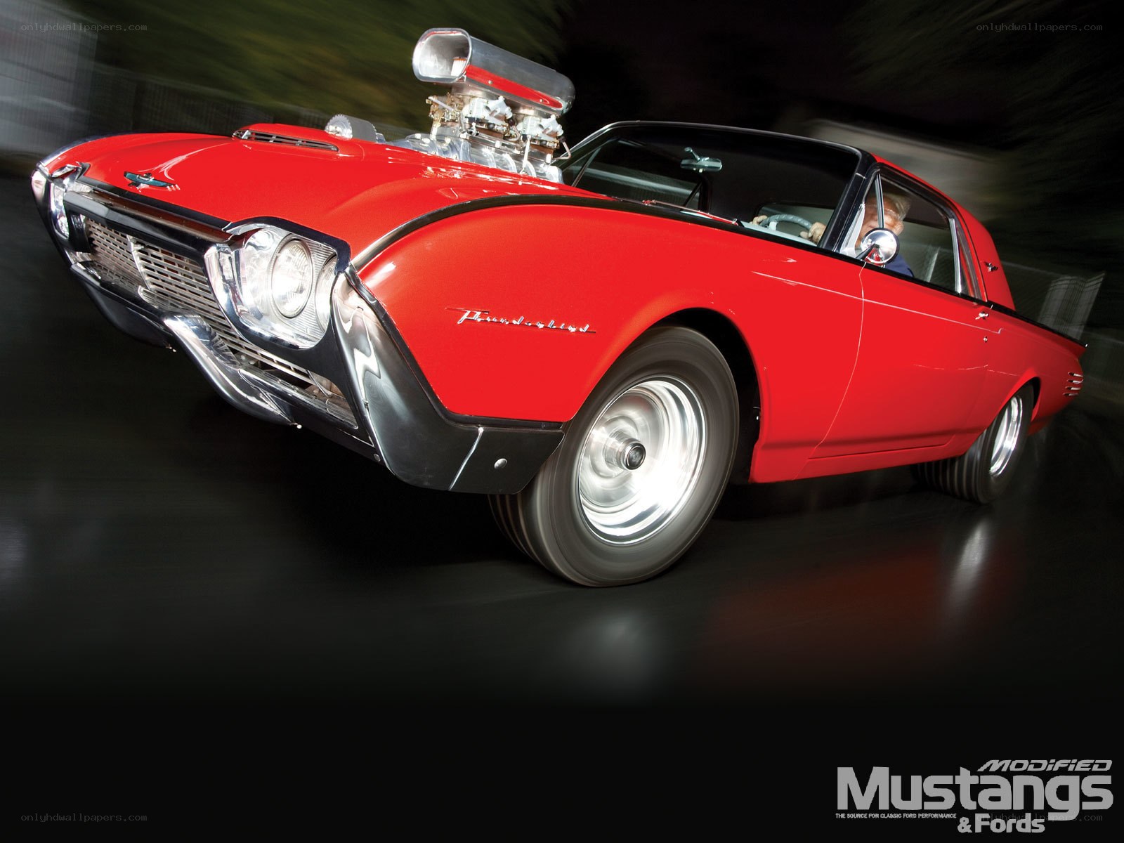 Red classic car in motion