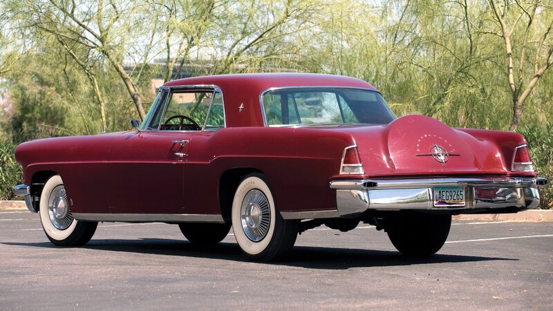 Red classic car in parking lot