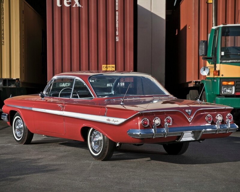 Red classic car in shipping yard
