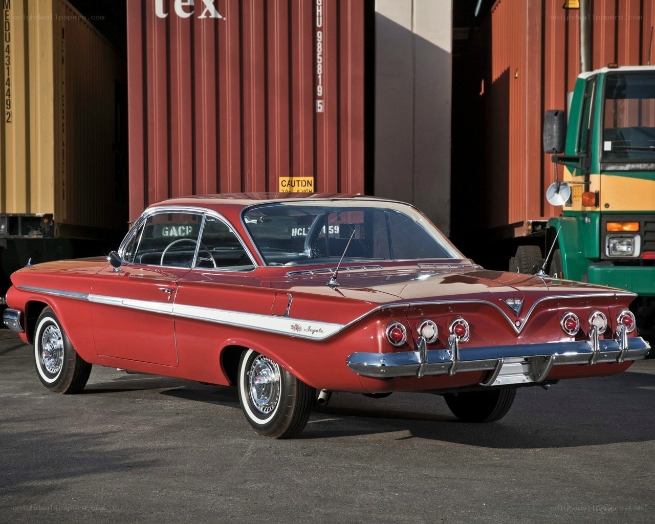Red classic car in shipping yard