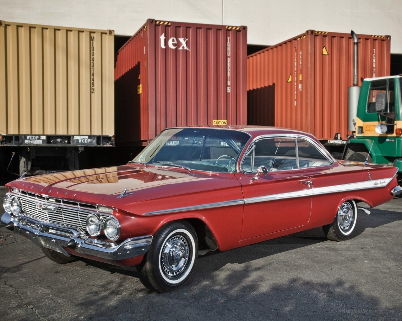 Red classic car in shipping yard