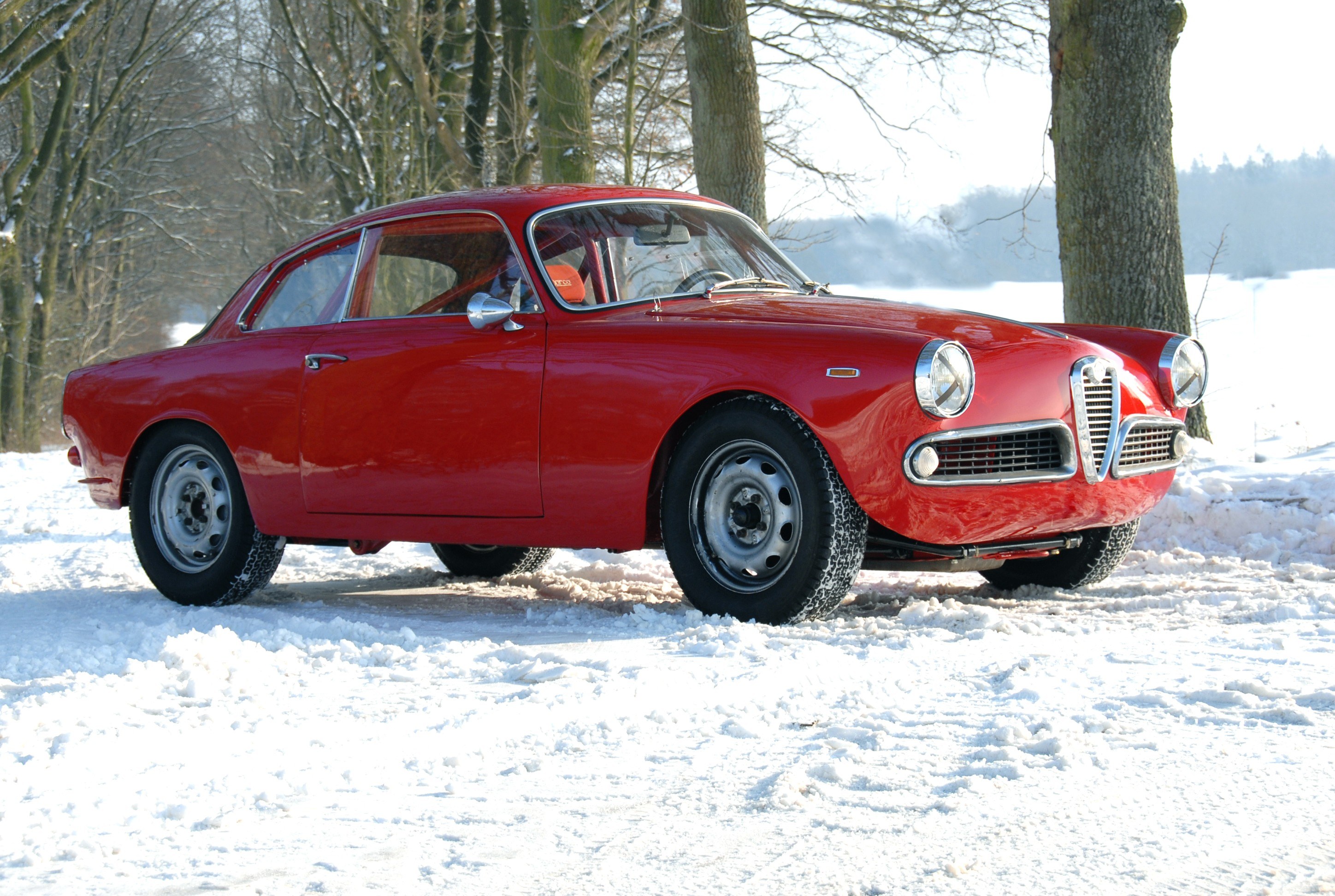 Red classic car in snow