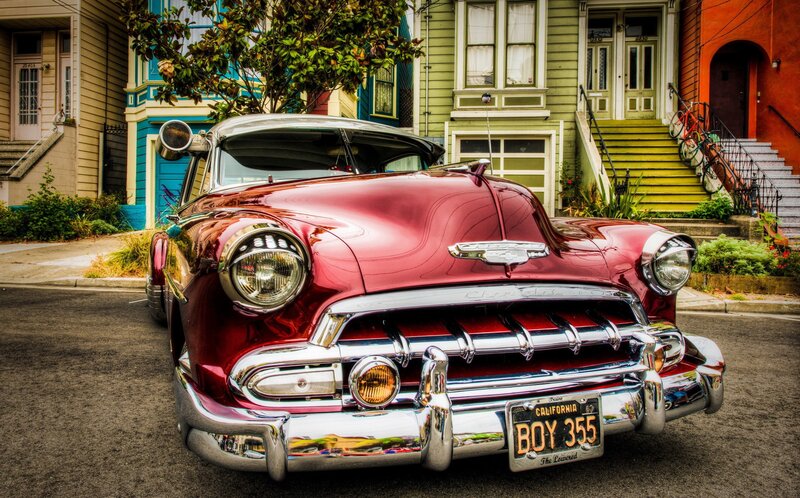 Red classic car on a city street