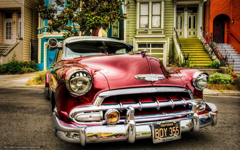 Red classic car on a city street