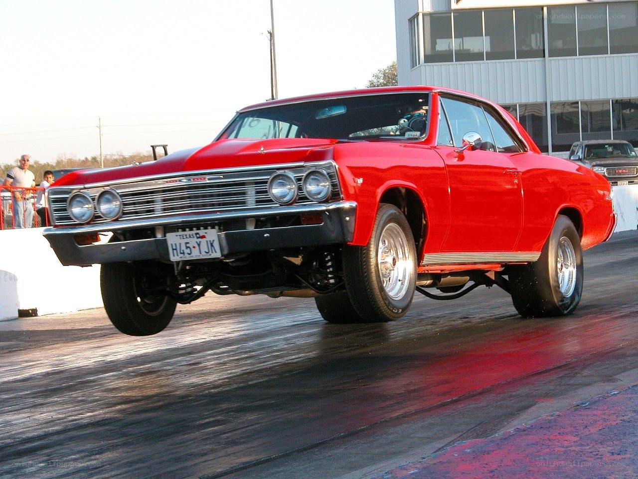 Red classic car on a drag strip
