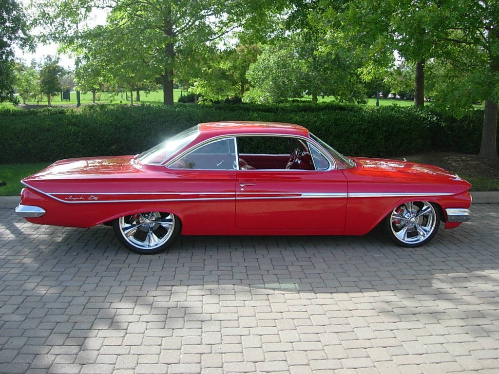Red classic car on a driveway