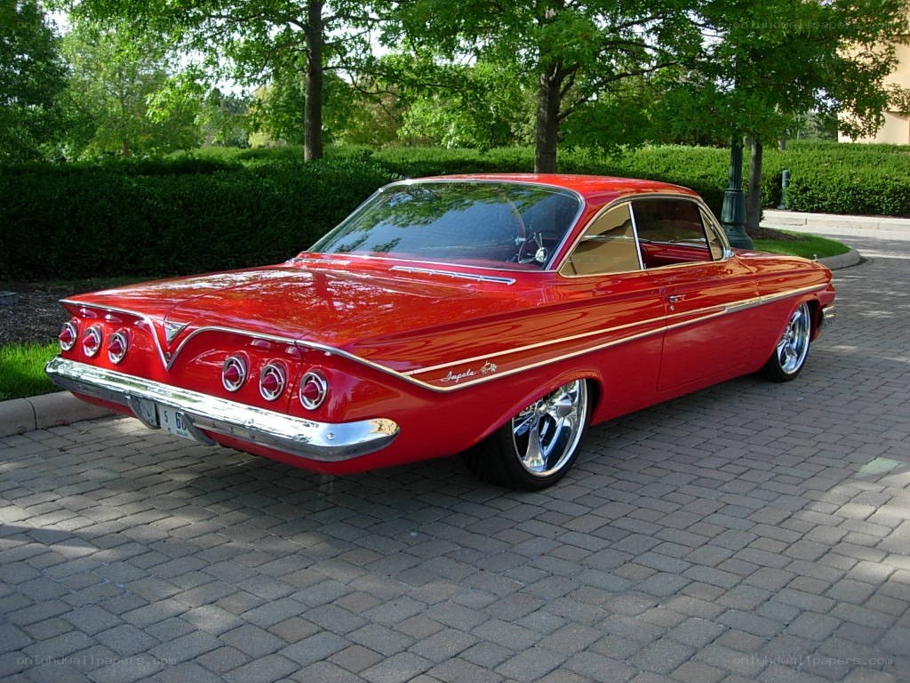 Red classic car on a driveway