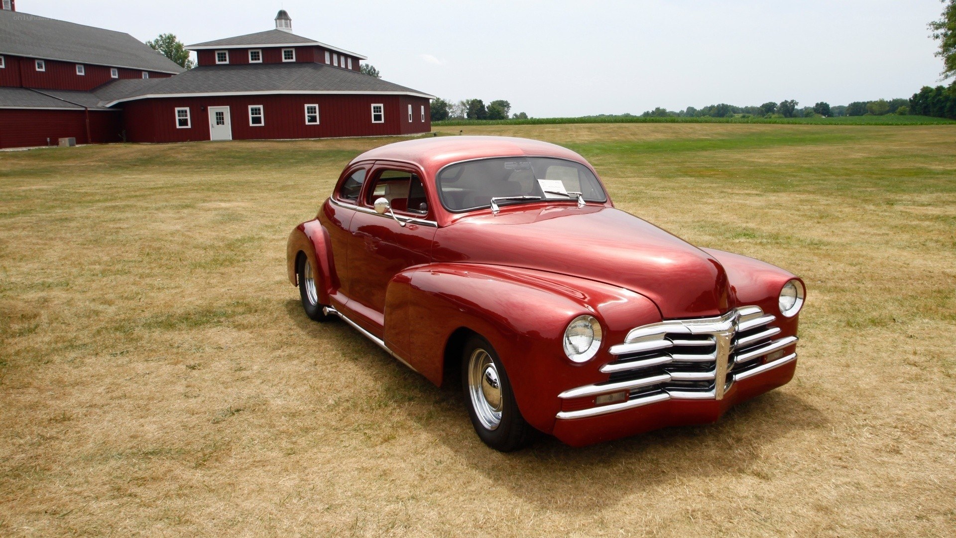 Red classic car on a field
