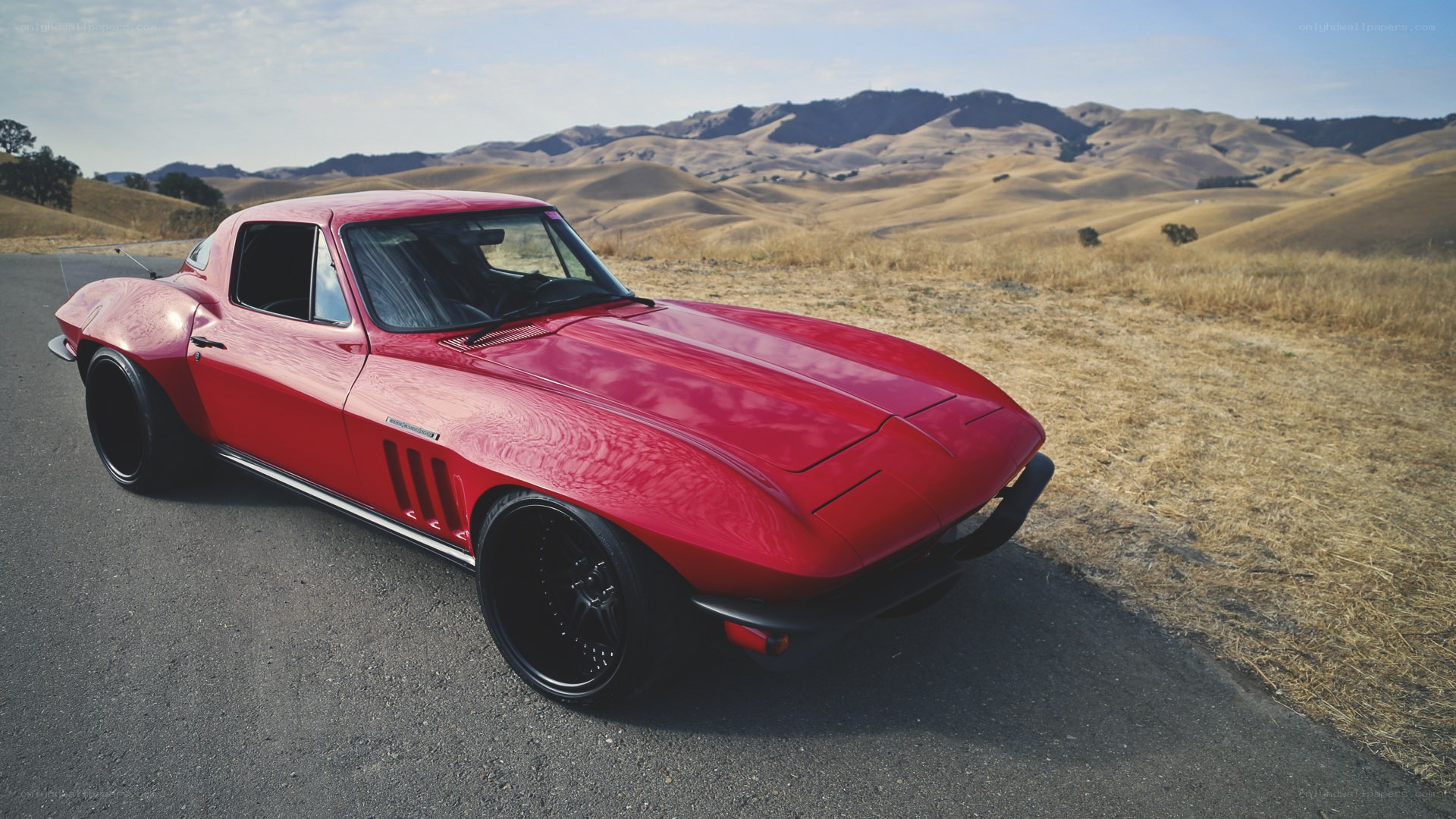 Red classic car on a hillside road
