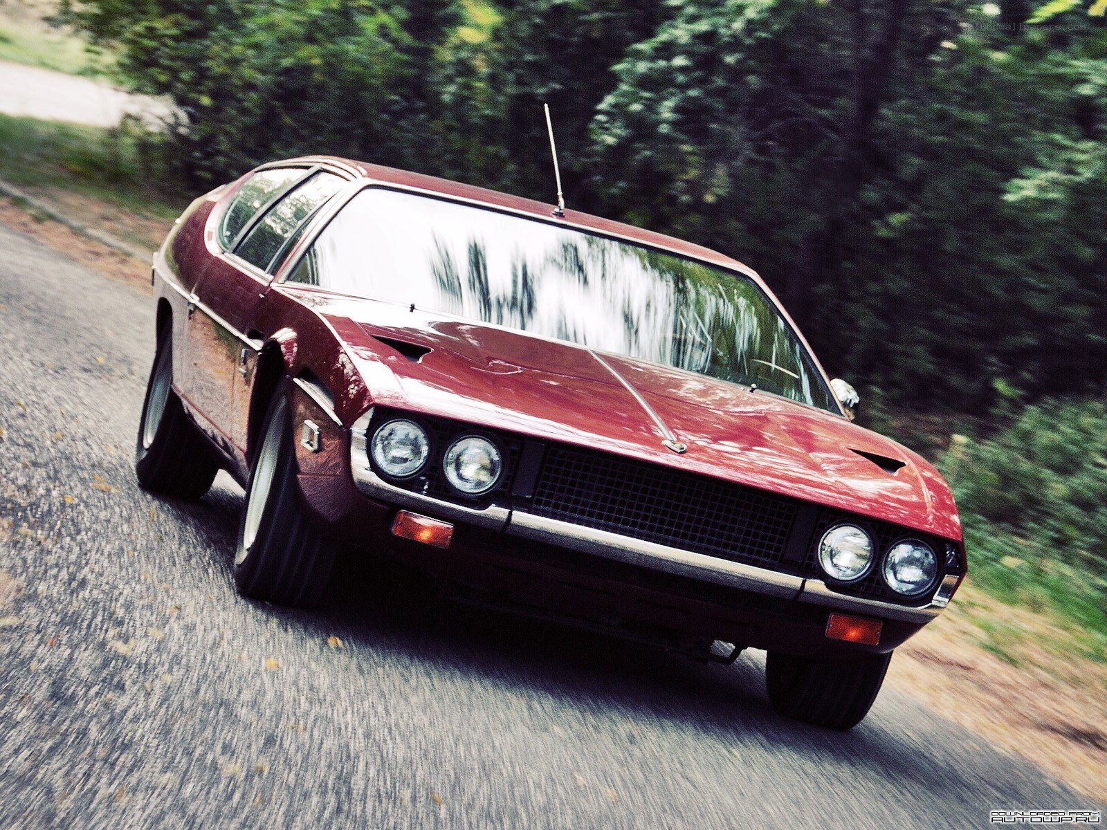 Red classic car on a road