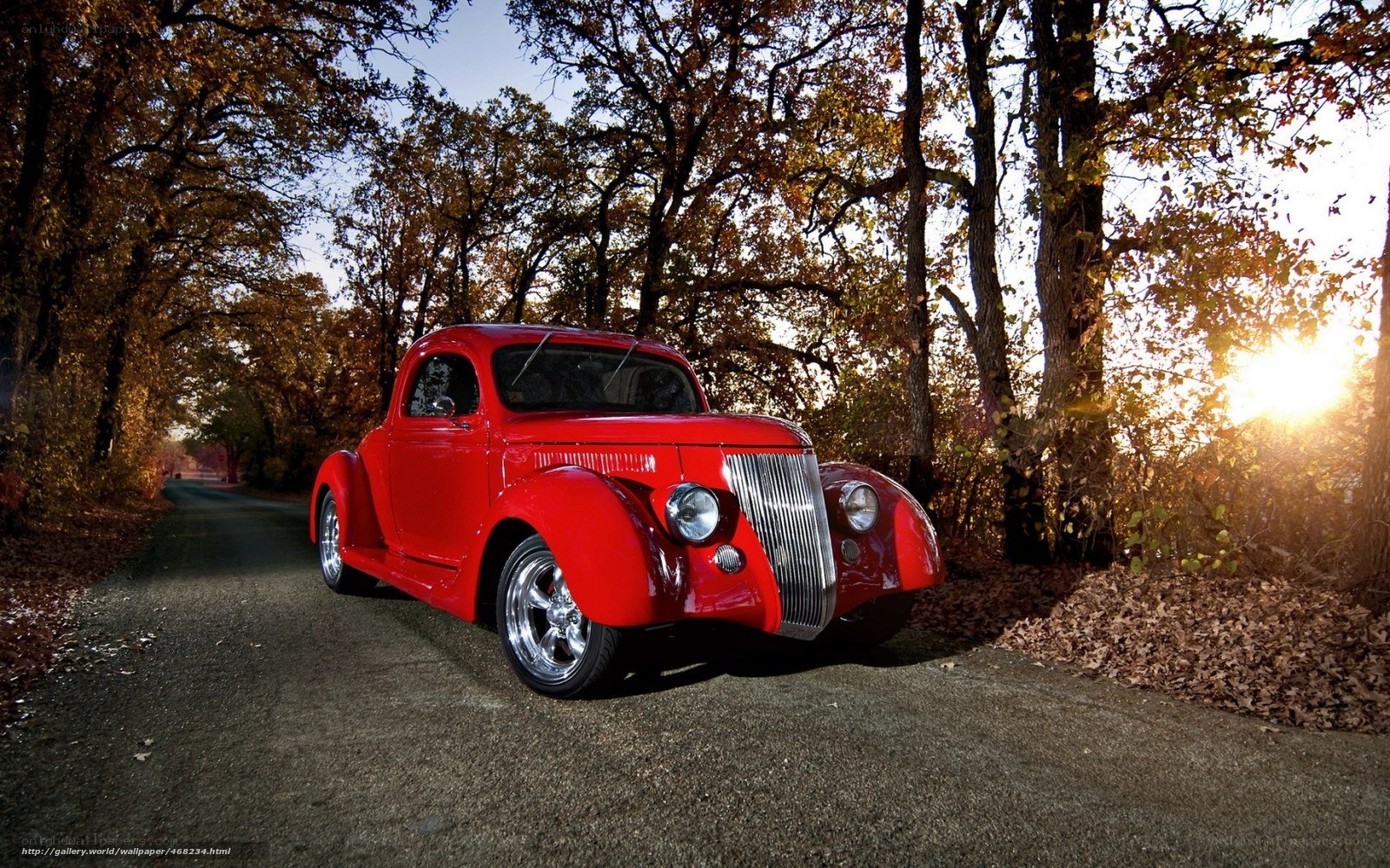 Red classic car on autumn road