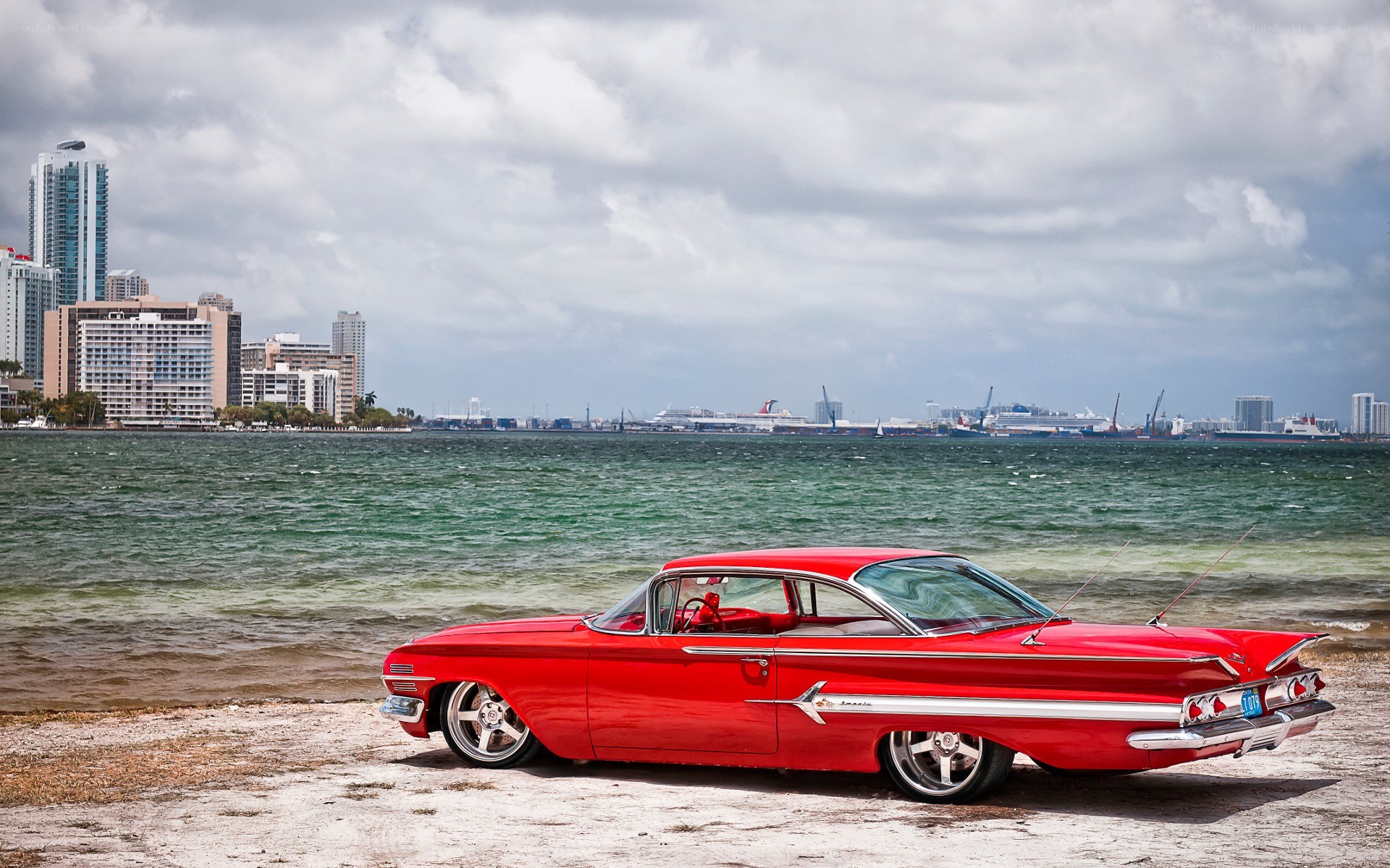 Red classic car on beach